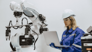 a woman in a hard hat and hardhat holding a laptop