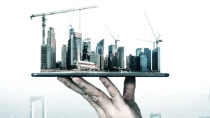 a hand holding a tablet with a city in the background